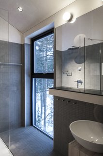 Go Stargazing in Snøhetta’s Towering Addition to Sweden’s Treehotel - Photo 6 of 7 - A bathroom and shower overlooks the surrounding forest.