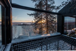 A double-layered net stretches between two bedrooms, providing an open terrace and a place to sleep under the night sky.