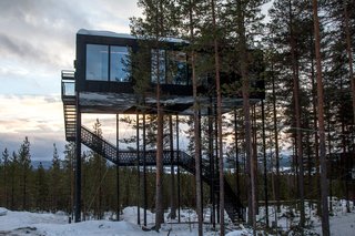 Go Stargazing in Snøhetta’s Towering Addition to Sweden’s Treehotel - Photo 7 of 7 - Guests ascend a staircase into the cabin, while a small lift carries up their luggage.