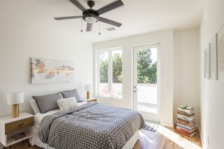 Ship Shape: An Austin Home With a Shipping Container Addition Asks $499K - Photo 4 of 9 - Both the master bedroom and second bedroom enjoy access to a private deck, perfect for reading, enjoying a cup of coffee, or simply lounging in the sun.