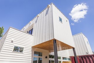 Ship Shape: An Austin Home With a Shipping Container Addition Asks $499K - Photo 6 of 9 - Rios asked architect Reynolds to derive a design from the shipping containers. The duplex takes the shape of stacked volumes clad with vertical and horizontal Hardie boards. The covered patio features clear-coated cedar wood.