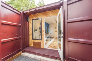 Ship Shape: An Austin Home With a Shipping Container Addition Asks $499K - Photo 8 of 9 - The front facade upcycles wood from the pallets used to ship in the cabinets. 