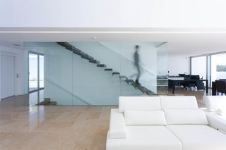 A floating staircase leads to the master bedroom with en suite bathroom, and a private terrace that affords the homeowner uninterrupted ocean views.