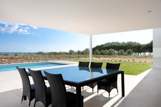 The outdoor patio provides an al fresco setting for entertaining by the pool.