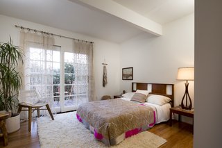 A Modified A-Frame Overlooking Los Angeles Starts at $699K - Photo 8 of 9 - The third bedroom on the main floor opens out onto a private terrace and has an additional space for storage or laundry. The house boasts a bonus room on the lowest floor that can be reached from an exterior stairwell.
