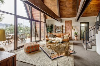 A Modified A-Frame Overlooking Los Angeles Starts at $699K - Photo 4 of 9 - The home recently saw new roofing, carpeting, and painting, as well as an updated HVAC system. The glass northern exposure ensures that the space is awash in natural light.