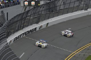 John Baldessari Blazes a Trail at the Daytona International Speedway With BMW Art Car #19 - Photo 7 of 11 - At the start of the race, the BMW M6 GTLM #24 keeps pace with #19. Unfortunately, vibration at the rear of the car takes it out of commission after 14 laps around the Daytona International Speedway.