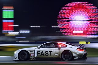 John Baldessari Blazes a Trail at the Daytona International Speedway With BMW Art Car #19 - Photo 9 of 11 - Night falls, the track is slick with rain, and the atmosphere of the infield grows more delirious as fans stay up to watch the race unfold.