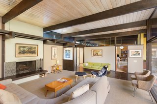 Snag This Midcentury Stunner in Southern California For $799K - Photo 6 of 10 - The fireplace in the living room provides a cozy setting for relaxing or entertaining. According to Matthew Berkley at Crosby Doe Associates, the design elements of the home recall the work of architects who had studied at USC—such as Fred McDowell.