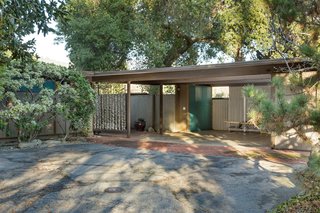 Snag This Midcentury Stunner in Southern California For $799K - Photo 1 of 10 - Set back from the street, the home provides privacy and seclusion. At the entrance, a carport leads to a brick-paved walkway that stretches to the front door.
