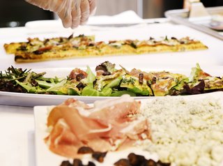 Signature Kitchen Suite’s Modern Pavilion Shines at KBIS - Photo 7 of 7 - Flatbread topped with prosciutto, stilton cheese, figs, and arugula was part of the menu at Signature Kitchen Suite's impressive 4,000-square-foot exhibition booth.