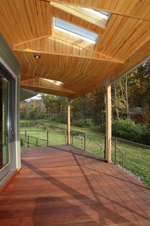The round home provides panoramic views of the surrounding woods and water.