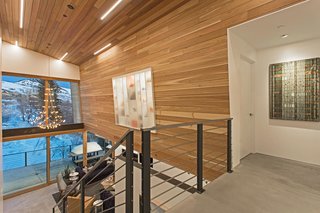 "Having walls for art was a huge consideration in the design," says Mullin. Upstairs, a shoe and purse display case creates a shadowbox effect.