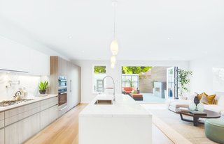 How to Set the Stage For Outdoor Living With Scenic Doors - Photo 3 of 5 - Here, Ultimate Bi-Fold Doors extend a interior living space into a open-air courtyard.