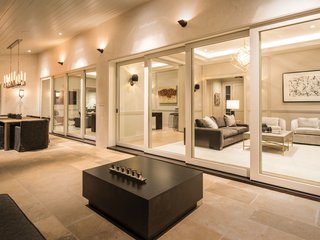 A Los Angeles Renovation Opens Up to Coastal Climes - Photo 2 of 3 - Another view of the patio reveals an outdoor dining space. The Ultimate Multi-Slide Door is also available in a pocket configuration, where panels are hidden in a wall compartment. These panoramic openings can stretch up to 56 feet wide and 12 feet high. 