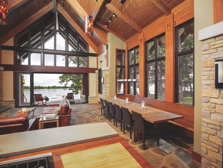 How to Set the Stage For Outdoor Living With Scenic Doors - Photo 1 of 5 - This home merges an open living space with a serene porch overlooking the water with a Marvin Ultimate Multi-Slide Door. 