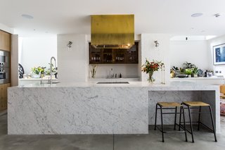 Stay in a Converted Victorian Cooperage in London - Photo 5 of 7 - Brass finishings and an eye-catching range hood contrast with cool Carrara marble.