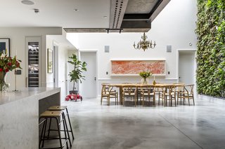 Stay in a Converted Victorian Cooperage in London - Photo 4 of 7 - The living room, kitchen, and dining room sit below street level in an open, communal area. A large, operable skylight measuring six by three meters allows light to stream over the dining table—the four glass panes had to be craned over the neighboring buildings.