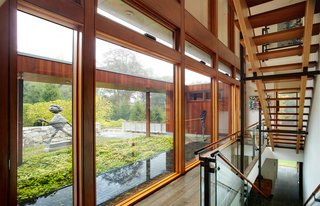 An Eliot Noyes Transformation in Connecticut Honors the Experimental Spirit of the Original - Photo 2 of 7 - A two-story glass curtain wall allows for natural light and views to permeate the space and the open stairs.