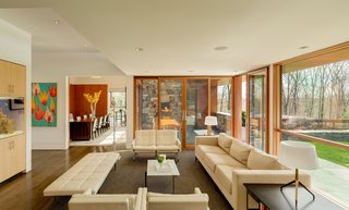 An Eliot Noyes Transformation in Connecticut Honors the Experimental Spirit of the Original - Photo 4 of 7 - The family room enjoys broad views of the landscaped property and leads to an outdoor terrace and fireplace.