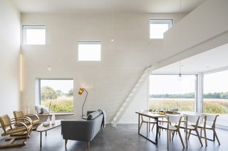 The 1,130-square-foot home features a spacious main living area with deliberately placed windows that frame the views. "Photography is all about framing," says Razavi. "It's as much about what you're not including in the picture as it is about what you're including." Likewise, the openings add intrigue to the rural landscape.