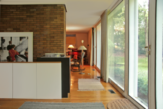 With $1 Million, You Can Save Philip Johnson’s First Commissioned House - Photo 2 of 9 - The entryway leads into the living room, and a low wall hides the staircase that leads to the lower level from view.