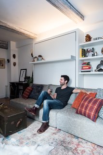 Big on Broadway, Small on Space: Inside the Studio of Actor Adam Kantor - Photo 2 of 5 - Strip lights above the Swing unit add height to the studio. ConcreteWall wall covering from Resource Furniture adorns the ceiling beams, an idea from designer Mike Harrison, who incidentally outfits many Broadway stars' dressing rooms.