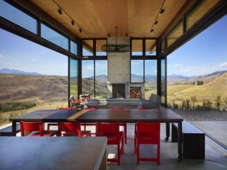A Steel-and-Glass Compound Is One Family’s Launchpad For Adventure - Photo 2 of 10 - The living room features glass walls that open up to the scenery, eliminating the barrier between interior and exterior.