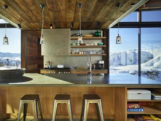 A Steel-and-Glass Compound Is One Family’s Launchpad For Adventure - Photo 4 of 10 - Wood siding salvaged from an old barn in Spokane, Washington, was repurposed for the project. "The varying tones of the wood reveal its history and use," says Kundig. Throughout the home, common materials are employed in fresh ways, such as exposed plywood used in the flooring and walls.