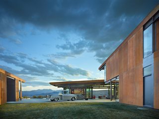 A Steel-and-Glass Compound Is One Family’s Launchpad For Adventure - Photo 9 of 10 - The courtyard-facing side of the garage provides an overhang for a multifunctional playroom or entertainment space.