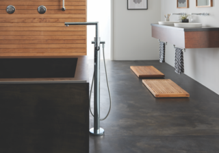 The One-Handle Tub Filler includes a handheld shower for versatile bathing options.