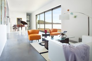 A 21-foot sliding glass pocket door opens up the living room to the outdoors, and the southern-facing opening captures winter sun. Throughout the home, windows and doors surpass Energy Star standards. The walls are made from 40% recycled material, and finished in non-VOC paint.