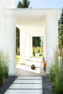 An open-air entry pavilion contributes to a sense of arrival at the home.