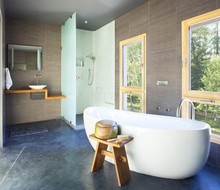 A deep soaking tub offers relaxation and views of the surrounding foliage.