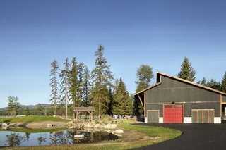 The outdoor arena is currently paved for vehicle storage, but it can be retrofitted to become a working riding ring.