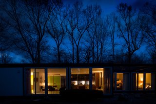 A Rare Midcentury Prefab Looks Just Like it Did in 1958—Down to the Knoll and Paul McCobb Interiors - Photo 13 of 13 - Generous stretches of glass allow the house to glow at night.