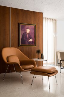 A Rare Midcentury Prefab Looks Just Like it Did in 1958—Down to the Knoll and Paul McCobb Interiors - Photo 3 of 13 - A Knoll Womb Chair is the perfect place to lounge off the living room. The homeowners replaced nine types of flooring—including linoleum and green shag carpeting—with terrazzo tiles and carpet in the bedrooms. 