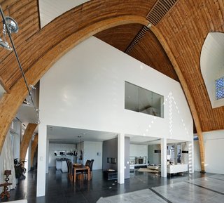 Traditional Churches Become Modern Homes - Photo 8 of 10 - Ruud Visser Architecten designed House In A Church within an old wooden church from 1930 that rests along the river De Rotte in Rotterdam. The massive interior could fit an average of six family houses inside so they chose to build the house as a separate entity inside the church, leaving space to see the transition between the two.
