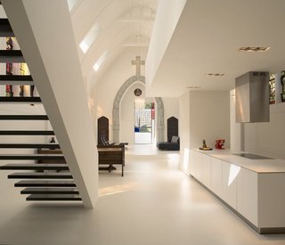 Traditional Churches Become Modern Homes - Photo 5 of 10 - Zecc Architecten transformed this old Catholic church in Utrecht, The Netherlands into a single family home while managing to work with its original character. Church benches were reintroduced in the dining area as seating and the stained glass illuminates the mostly-white interior with colors and history.