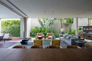 In order to give the clients what they wanted, the house takes up most of the property with no real yard. To bring in greenery, they lined the perimeter with plants. Large sliding glass doors open the living room up to the pool deck making those vertical gardens feel like they’re indoors.