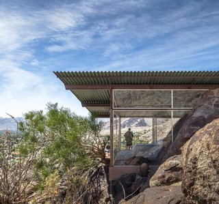 8 Iconic Houses in Palm Springs, California - Photo 4 of 8 - The Frey House II was built in 1964 by architect Albert Frey with mostly glass walls that frame the surrounding rocky landscape. The house even incorporates the massive rocks inside where many would have excavated the material or chosen not to have built there.