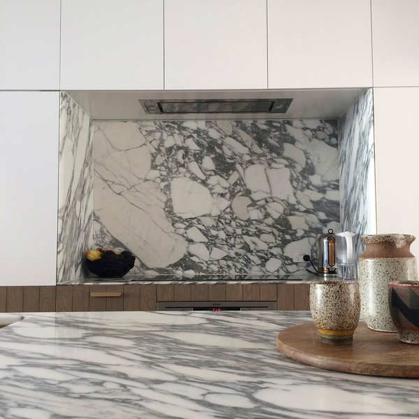 Carrara marble with a shark nose edge is an everyday reminder of the melting pack ice at the Earth’s poles. The pleasure of working in a compact terrace house is that the space restrictions in the kitchen discourage the inclusion of extra-large or multiple ovens, and the oversized fridges full of spoiling food.
© Sean Johnson
Photo 11 of Bougainvillea Row House modern home