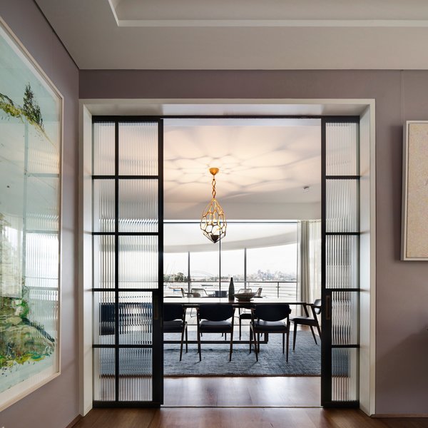 Brasilian ribbed glass in steel framed doors frame the jewellery inspired Herve van der Straeten lustre.
www.vanderstraeten.fr
© Justin Alexander Photo 15 of Harbour Front-Row Seat modern home