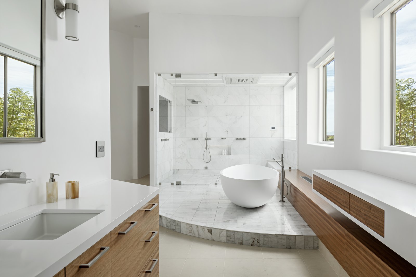 Both vanities with freestanding tub and steam shower in the background