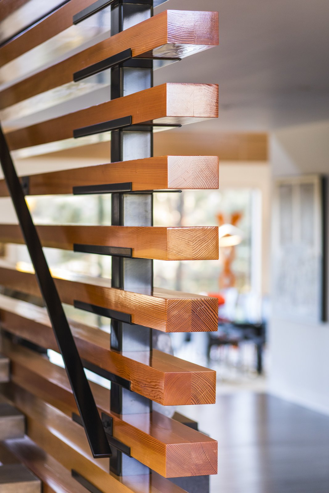 The entry/stair screen wall is made of fir timber that was slipped over steel posts and sits on a custom made bracket.