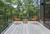 Lake Home on Lake Lanier : The clients desired a home that could celebrate the lakeside site, for its views and trees. A home that could provide private spaces for owners and their guests, yet provide places for everyone to gather. Connection to the outside was of most importance, both visually thru the large windows and via the sliding glass doors. Photo of Lake House modern home