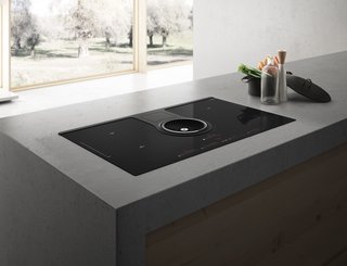 Kitchen News and Trends from Cologne - LivingKitchen 2017 - Photo 3 of 7 - NikolaTesla is the first induction cooktop with a fully integrated air suction system. The central fan, a cooker hood perfectly integrated into the cooktop itself, guarantees high performance in terms of fume capture, silence and energy efficiency.