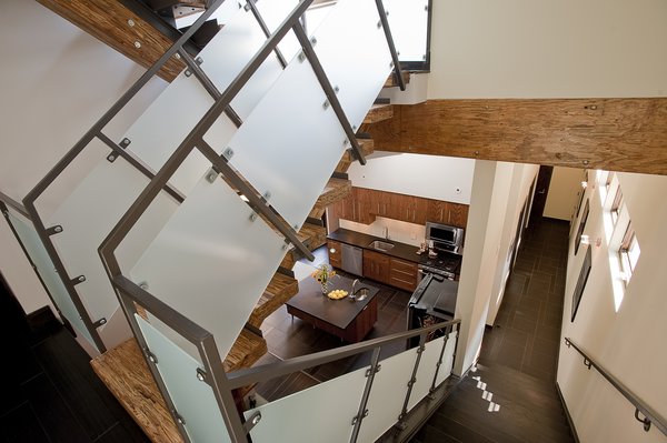 Located on 22nd Street, Silver Top House sits between the neighborhood’s dense residential row houses and the large scale industrial district. The home’s massing responds to the linear and angular warehouse bridge, while the 22nd street façade looks to the residential row houses for proportion and fenestration relationships. Photo 2 of Silver Top House modern home