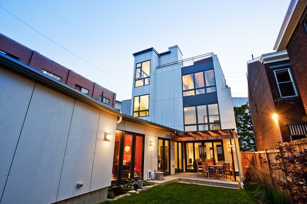 Diagrammatically the house is made up of two massing elements, a linear, horizontal brick-clad wing that anchors the site corner and extends down the industrial alley, and a three-story block mass that maintains the residential contextual massing. These two forms are brought together around the knuckle of the house – the vertical focal point of the home. Photo 3 of Silver Top House modern home