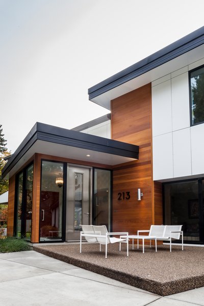 While maintaining the existing house structure, an entirely new, modern home was created from new interiors placed on to a new exterior skin. The entire exterior was revised with new cladding, metal roof, insulation, and windows. An addition opened the space to embrace higher ceilings and to introduce varying floor levels in order to create a fresh, dynamic flow within the home. The re-cladding of the house allowed for a complete change in the home’s style while also completing significant thermal improvements. Photo of Creek Drive Residence modern home